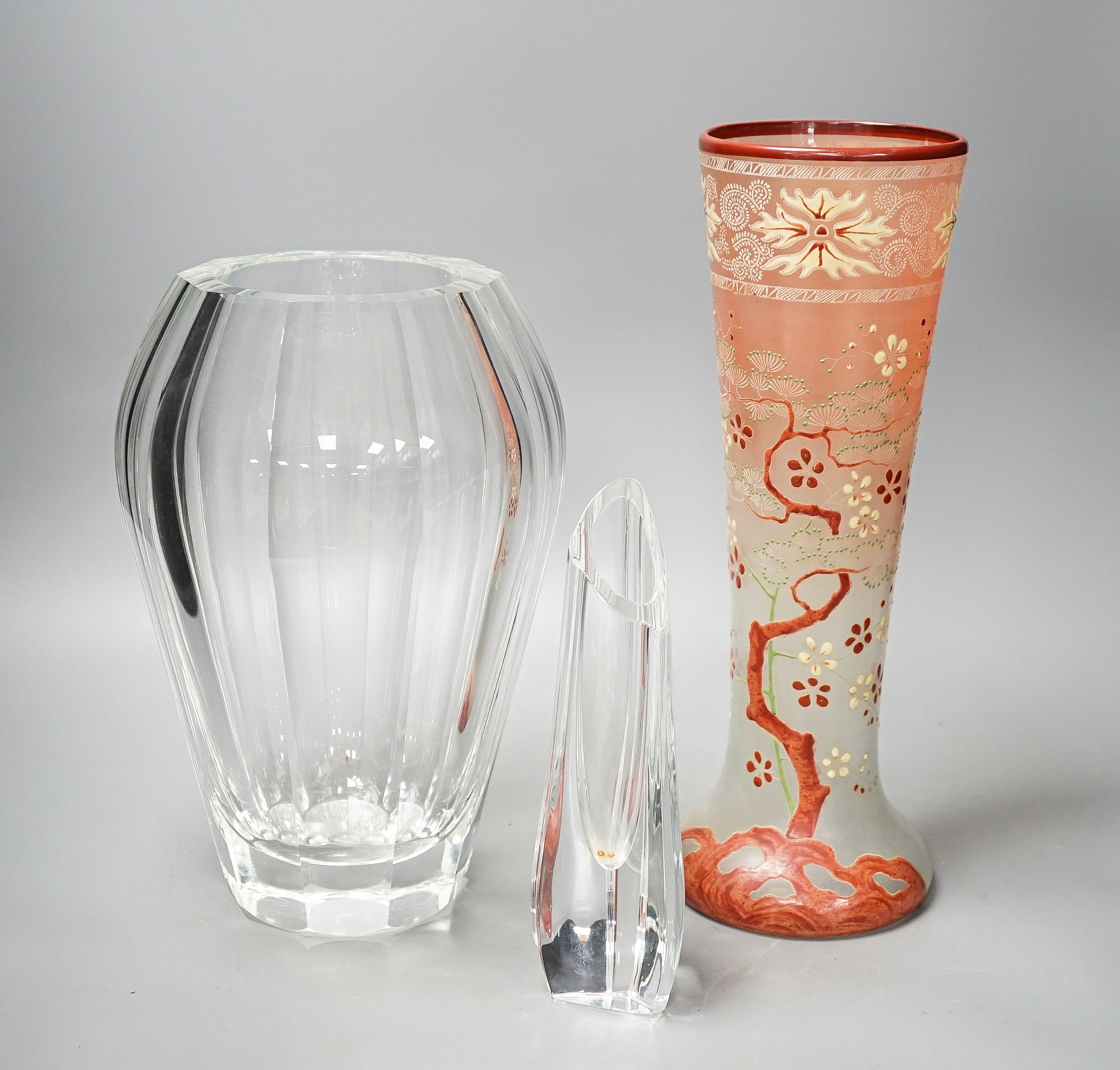 A tall Bohemian enamelled glass vase, 35cm, manner of Moser, a Moser heavy facet cut glass vase, 29.5cm, etched mark, and a Baccarat moulded glass vase (3)